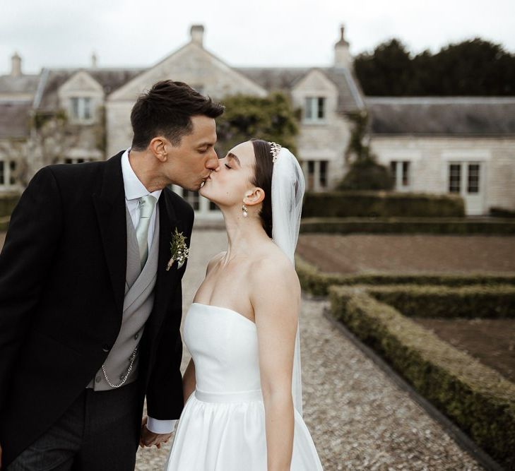 Bride In Strapless Wedding Dress With Bouquet And Veil