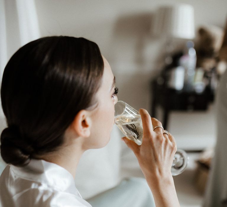 Bride Takes A Sip Of Champagne