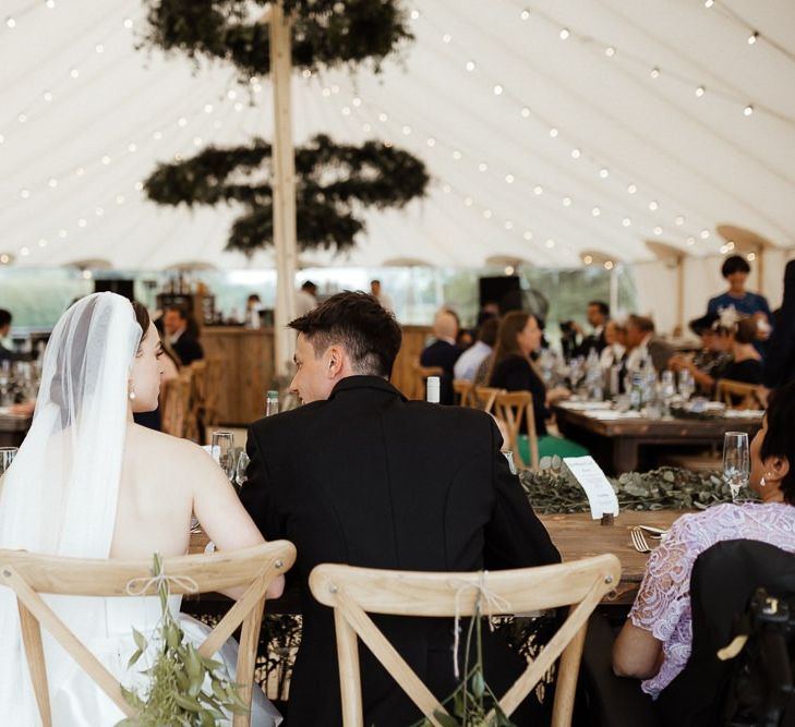 Bride In Strapless Wedding Dress During Reception With New Husband