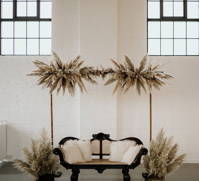 Seating Area with Love Seat and Pampas Grass Floral Installation