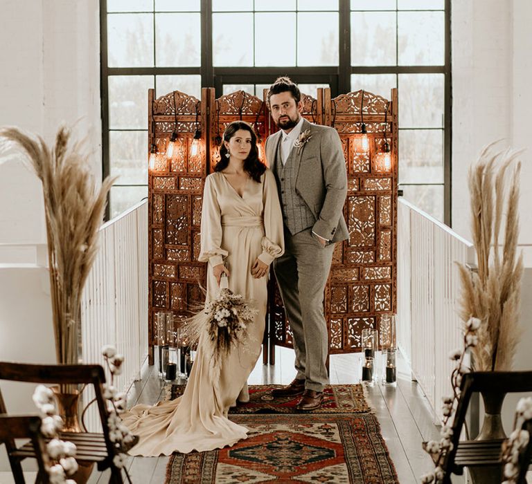 Bride and Groom Standing in Front of the Moroccan Screen Altar Backdrop