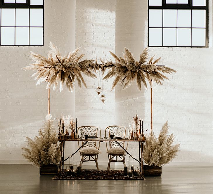 Industrial Wedding Venue with Sweetheart Table Decorated with Pampas Grass Installation