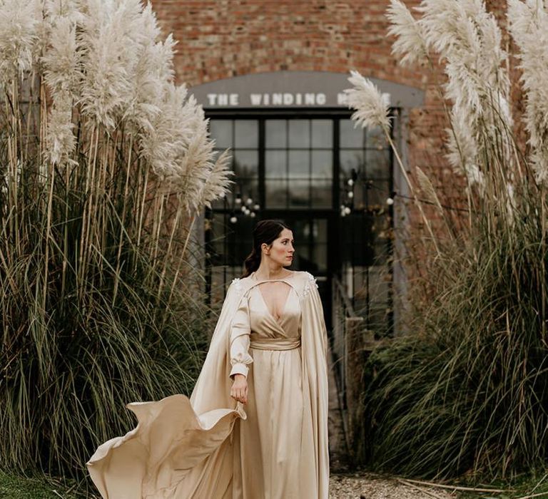 Stylish Bride in Gold Satin Wedding Dress with Matching Cape