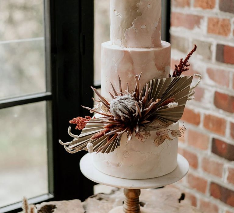 Wedding Cake Decorated with a King Protea and Dried Palm Leaf