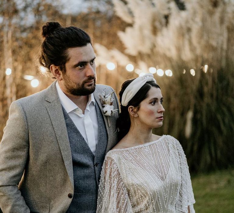 Stylish Bride in Sequin Wedding Dress and Turban Headdress and Groom in Wool Suit and Top Knot