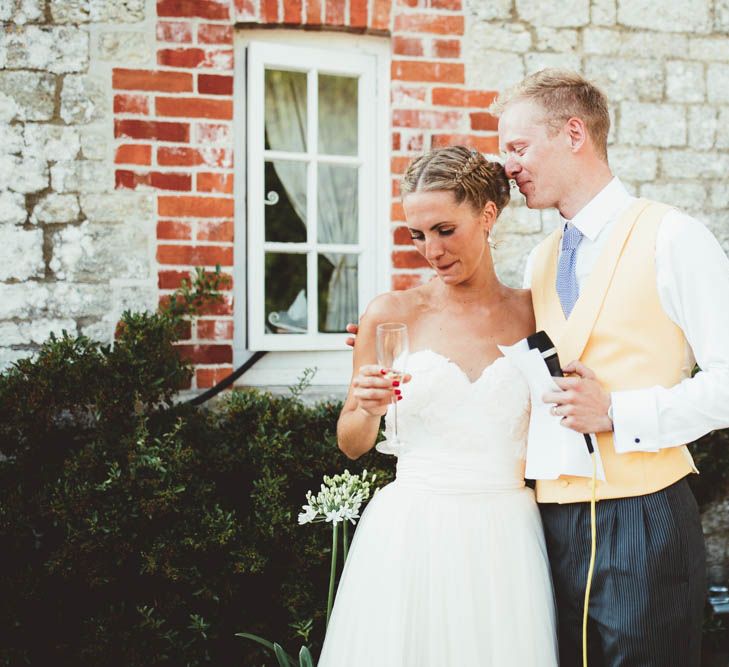 Bride and Groom Hugging During Wedding Speech