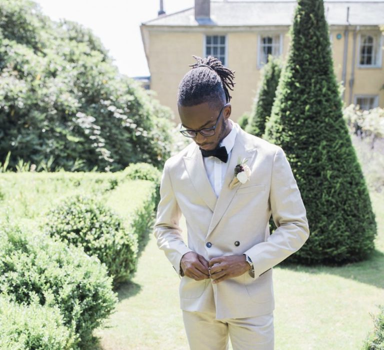 Groom in beige suit at The Old Rectory Estate Italian micro themed wedding