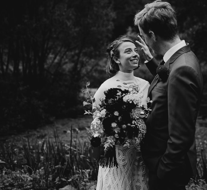 Black and White Portrait of  Bride in Crochet Wedding Dress and Woollen Jumper and Groom in Navy Suit