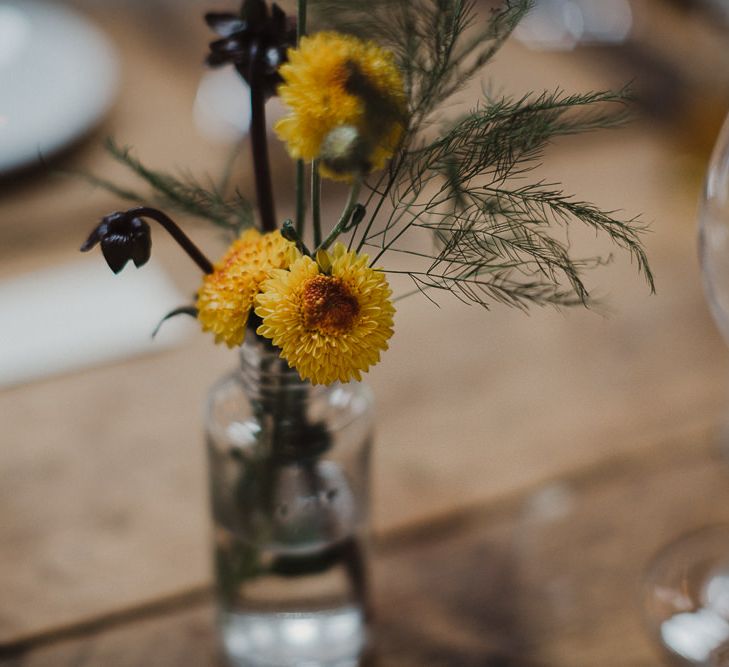 Yellow Dahlia's in a Glass Bottle as Centrepieces