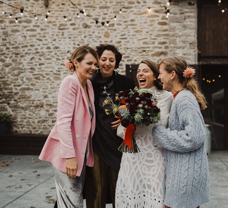 Bride in Crochet Wedding Dress and Woollen Jumper Laughing with her Best Friends