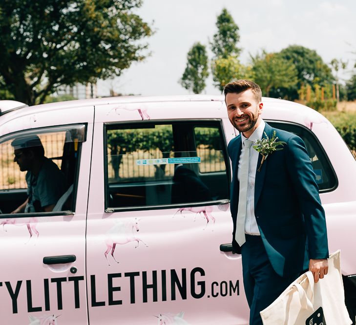 Arrival of the Grooms | Pink London Taxi | Groom in Dark Petrol Blue Suit by Paul Smith | Same Sex Wedding with Industrial Styling at Wimborne House | Marmelo Photography