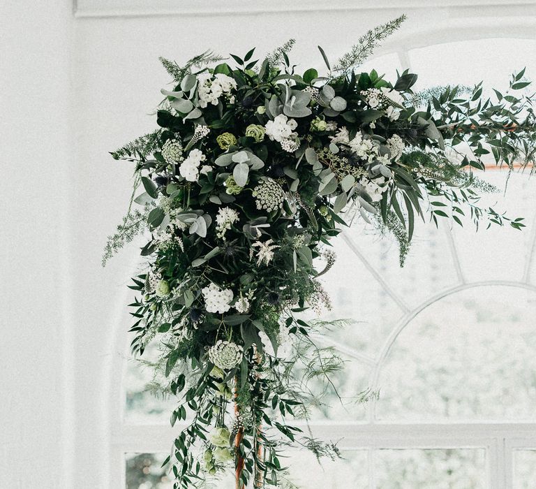 Wedding Ceremony Decor | Copper Arch with White Flowers and Foliage | Whitewashed Walls | Same Sex Wedding with Industrial Styling at Wimborne House | Marmelo Photography