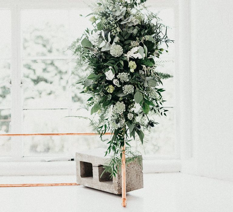 Wedding Ceremony Decor | Copper Arch with White Flowers and Foliage | Whitewashed Walls | Same Sex Wedding with Industrial Styling at Wimborne House | Marmelo Photography