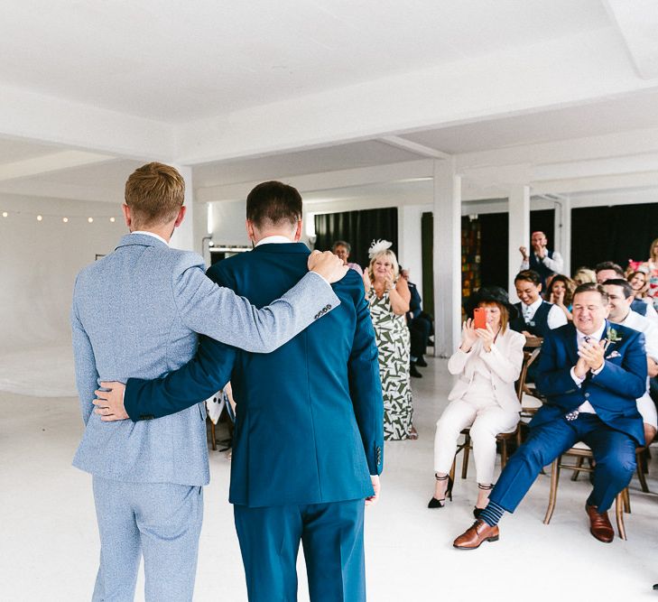 Wedding Ceremony | Just Married | Festoon Lights | Groom in Dark Petrol Blue Suit by Paul Smith | Groom in Light Blue Made-To-Measure Suit by Beggars Run | Same Sex Wedding with Industrial Styling at Wimborne House | Marmelo Photography