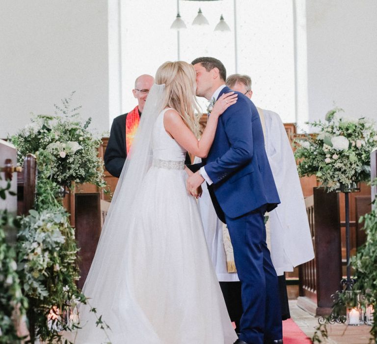 You may now kiss the bride moment at church wedding ceremony