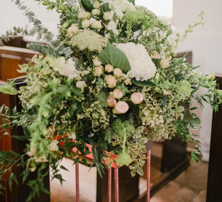 Green, white and pink church wedding flower arrangement