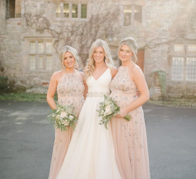 Bride in Sassi Holford wedding Dress and bridesmaids in halter neck dresses