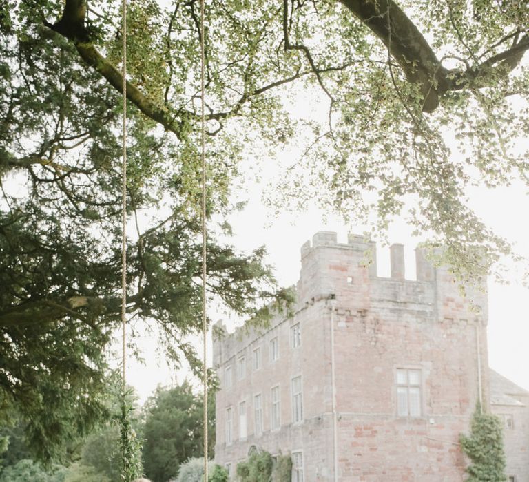 Bride and groom portrait on the swing at Askham Hall wedding venue