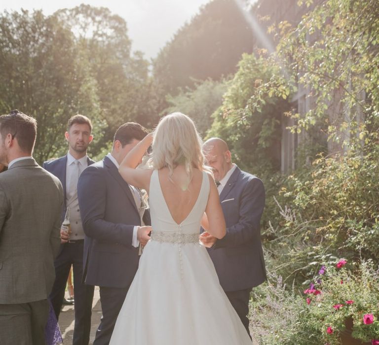 Bride in Sassi Holford wedding dress and belt