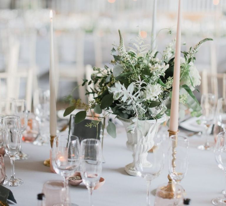 Romantic table centrepiece decor with flowers and taper candles