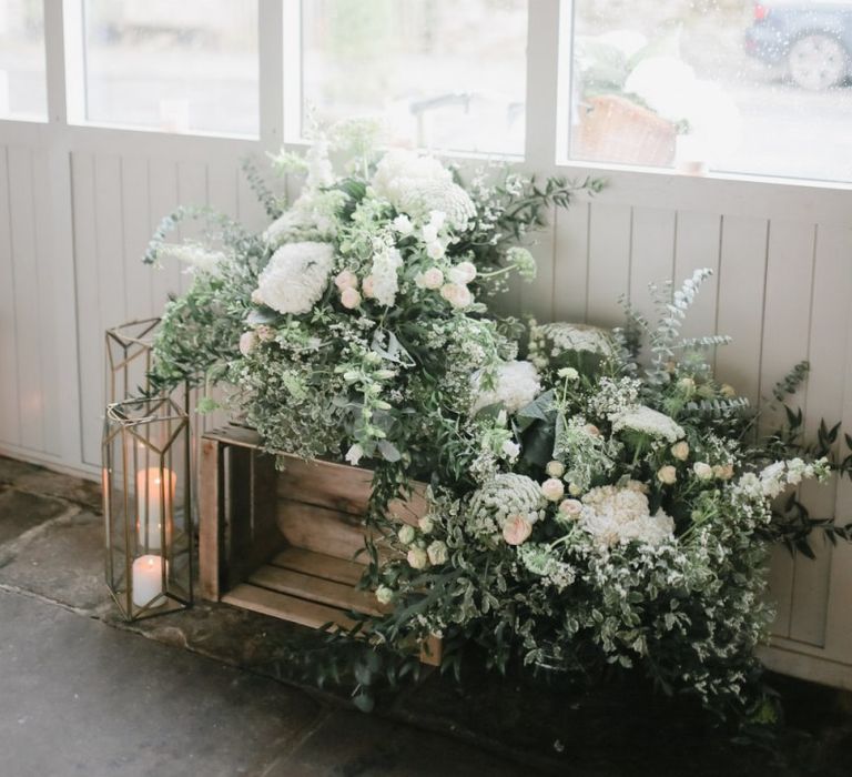 Rustic crate, lantern and flower wedding decor at Askham Hall