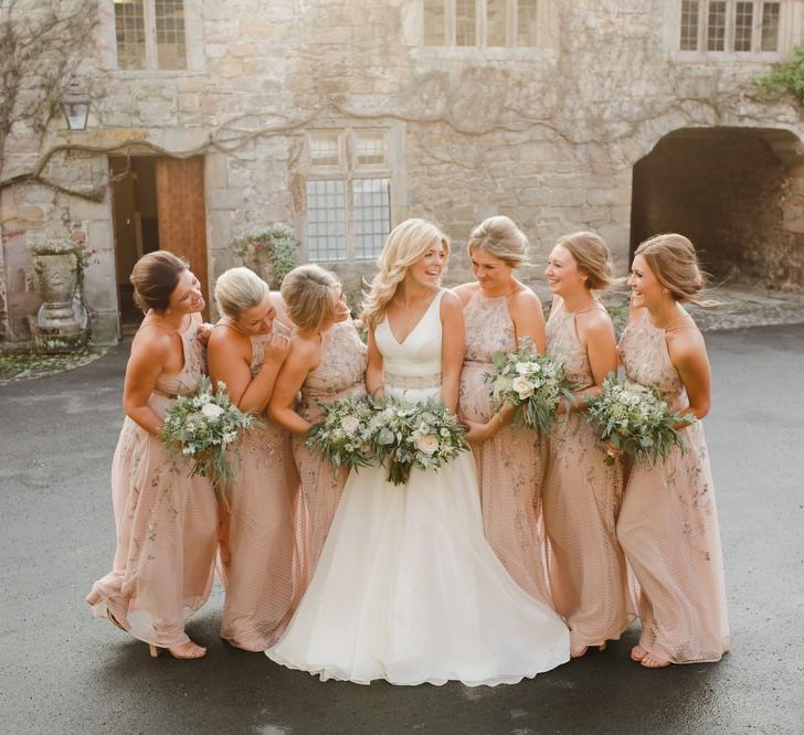 bridal party portrait at Askham Hall with bridesmaids in pink dresses