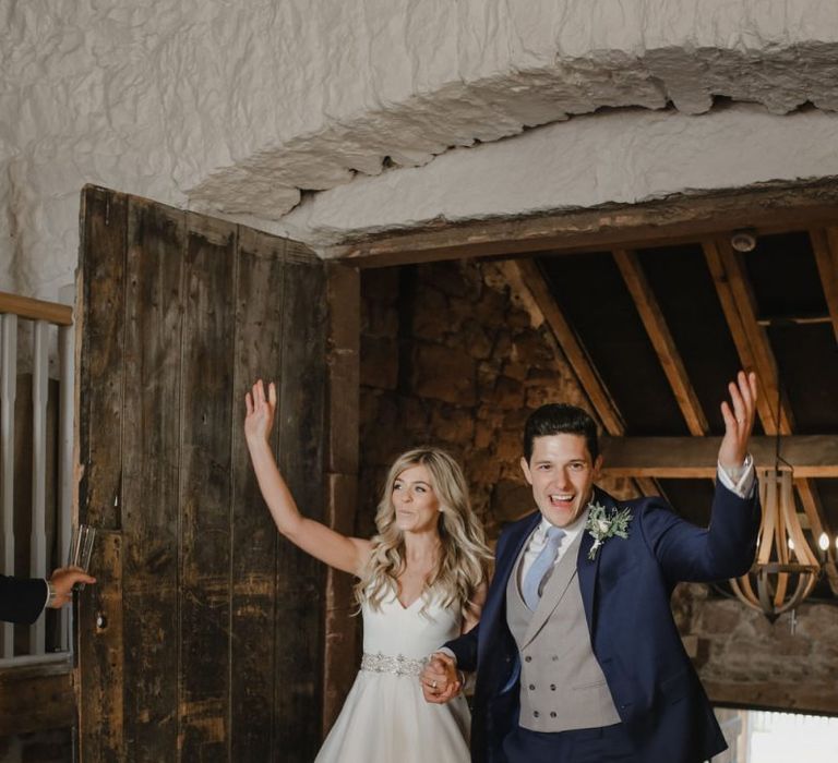 Bride and groom entering their Askham Hall wedding reception