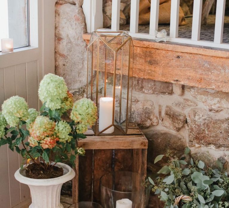 Flower pot, lantern and wooden crate wedding decor at Askham Hall