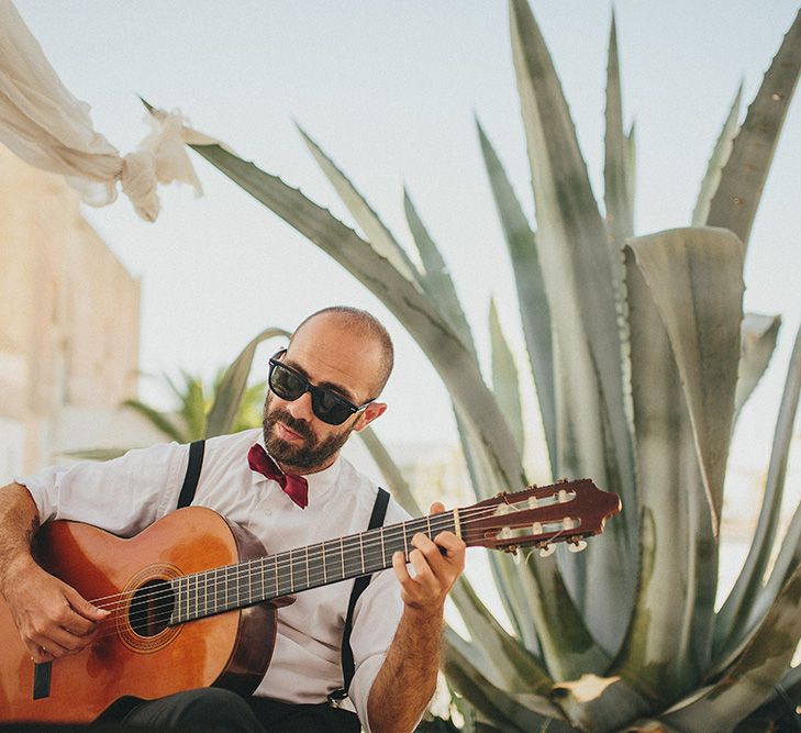 Outdoor Wedding Ceremony | Guitarist | Brightly Coloured Destination Wedding at Masseria Potenti Wedding Venue, Puglia, South Italy | Petar Jurica Photography | Marco Odorino Film