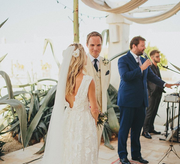 Outdoor Wedding Ceremony | Bride in Custom Clemence Halfpenny London Bridal Gown | Groom in Cream Three Piece Suit | Brightly Coloured Destination Wedding at Masseria Potenti Wedding Venue, Puglia, South Italy | Petar Jurica Photography | Marco Odorino Film