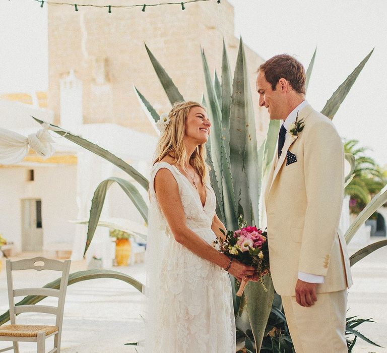 Outdoor Wedding Ceremony | Bride in Custom Clemence Halfpenny London Bridal Gown | Groom in Cream Three Piece Suit | Brightly Coloured Destination Wedding at Masseria Potenti Wedding Venue, Puglia, South Italy | Petar Jurica Photography | Marco Odorino Film