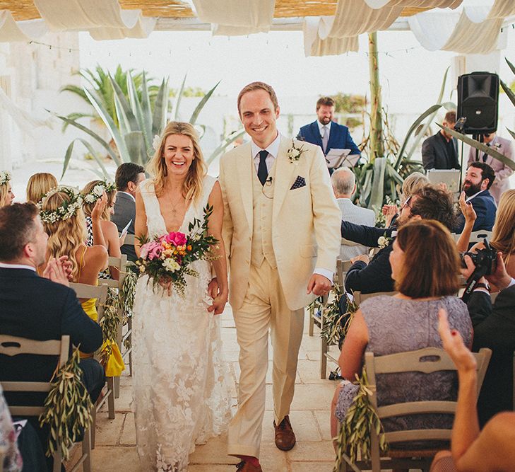 Outdoor Wedding Ceremony | Bride in Custom Clemence Halfpenny London Bridal Gown | Groom in Cream Three Piece Suit | Brightly Coloured Destination Wedding at Masseria Potenti Wedding Venue, Puglia, South Italy | Petar Jurica Photography | Marco Odorino Film