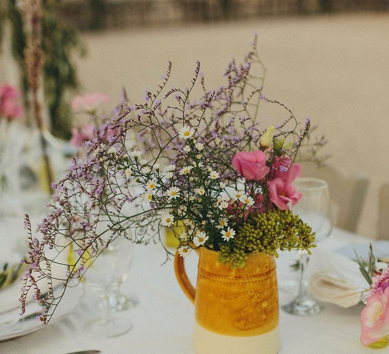 Wild Flowers in Pitcher Jug | Wedding Decor | Brightly Coloured Destination Wedding at Masseria Potenti Wedding Venue, Puglia, South Italy | Petar Jurica Photography | Marco Odorino Film