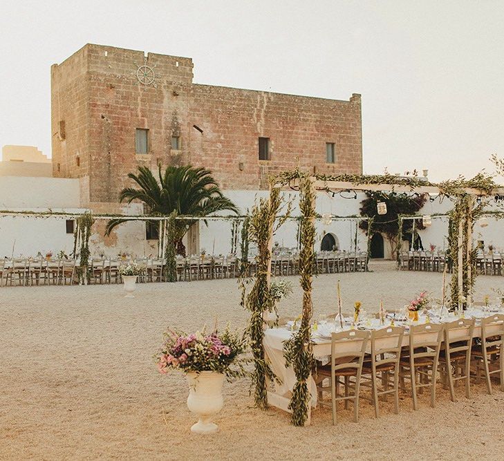 Outdoor Wedding Reception with Vines | Brightly Coloured Destination Wedding at Masseria Potenti Wedding Venue, Puglia, South Italy | Petar Jurica Photography | Marco Odorino Film