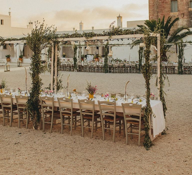 Outdoor Wedding Reception with Vines | Brightly Coloured Destination Wedding at Masseria Potenti Wedding Venue, Puglia, South Italy | Petar Jurica Photography | Marco Odorino Film