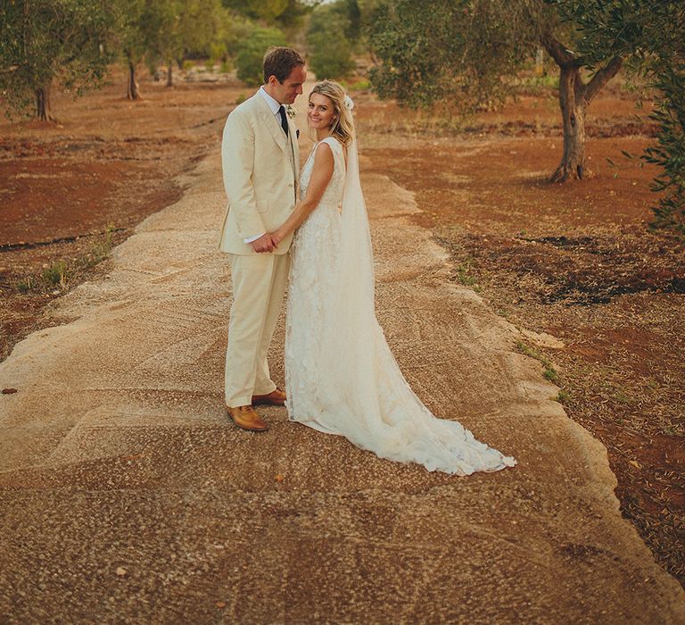 Bride in Custom Clemence Halfpenny London Bridal Gown | Groom in Cream Three Piece Suit | Brightly Coloured Destination Wedding at Masseria Potenti Wedding Venue, Puglia, South Italy | Petar Jurica Photography | Marco Odorino Film