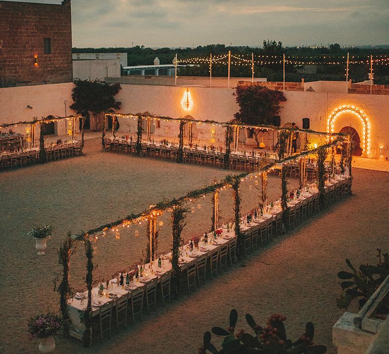 Outdoor Wedding Reception with Fairy Lights | Brightly Coloured Destination Wedding at Masseria Potenti Wedding Venue, Puglia, South Italy | Petar Jurica Photography | Marco Odorino Film