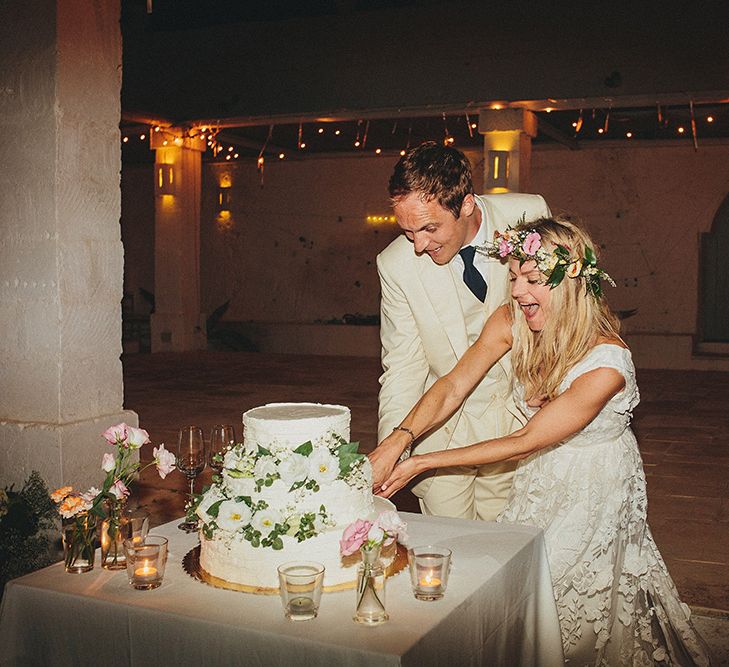 Cutting the Cake | Bride in Custom Clemence Halfpenny London Bridal Gown | Groom in Cream Three Piece Suit | Brightly Coloured Destination Wedding at Masseria Potenti Wedding Venue, Puglia, South Italy | Petar Jurica Photography | Marco Odorino Film