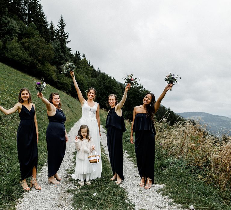 Bridal Party Picture in the French Alps with Bride in Mariées Passion Wedding Dress and Bridesmaids in Navy Dresses