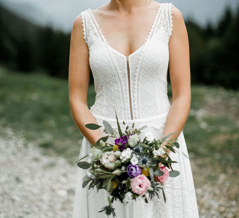 Bride in Mariées Passion Wedding Dress with  Purple, Pink, White and Green Wedding Bouquet