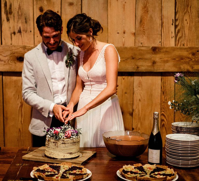 Bride and Groom Cutting The Single Tier Semi Naked Wedding Cake