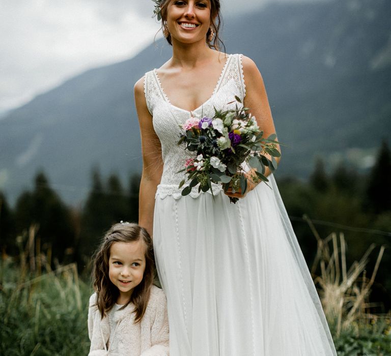 Bride in Mariées Passion Wedding Dress with Wedding Bouquet and Flower Girl with Basket