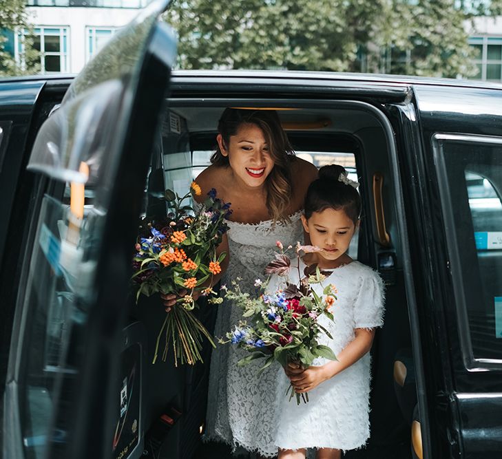 Bride in Lace Whistles Wedding Dress with High/Low Hem and Bardot Neckline | Flower Girl in White Zara Dress with Short Sleeves and Scoop Back | Wedding Bouquets with Bright Wild Flowers | High Street Wedding Dress for an Intimate Crouch End Pub Wedding with Bright Flowers | Miss Gen Photography