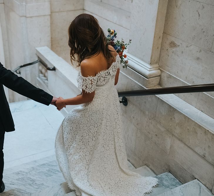 Bride in Lace Whistles Wedding Dress with High/Low Hem and Bardot Neckline | Groom in Black Reiss Jacket and Black Nudie Jeans with Church's Shoes | Bridal Bouquet with Bright Wild Flowers | Wedding Ceremony at Old Marylebone Town Hall | High Street Wedding Dress for an Intimate Crouch End Pub Wedding with Bright Flowers | Miss Gen Photography