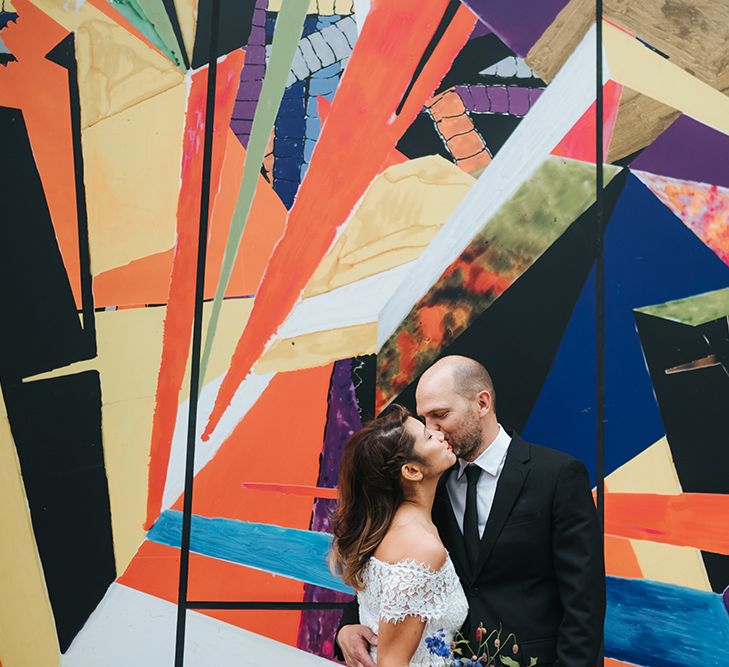 Bride in Lace Whistles Wedding Dress with High/Low Hem and Bardot Neckline | Groom in Black Reiss Jacket and Black Nudie Jeans with Church's Shoes | Bridal Bouquet with Bright Wild Flowers | High Street Wedding Dress for an Intimate Crouch End Pub Wedding with Bright Flowers | Miss Gen Photography