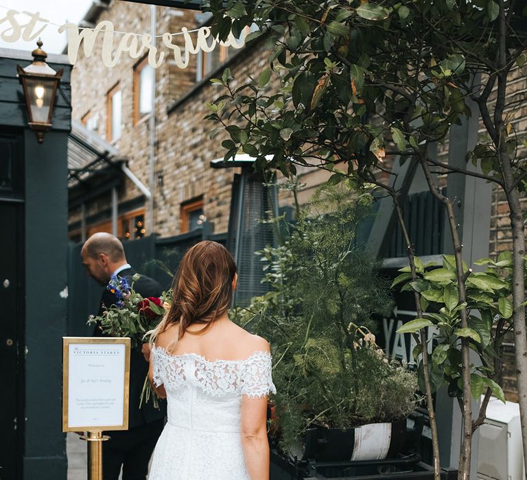 Bride in Lace Whistles Wedding Dress with High/Low Hem and Bardot Neckline | Groom in Black Reiss Jacket and Black Nudie Jeans with Church's Shoes | Bridal Bouquet with Bright Wild Flowers | Victoria Stakes Pub Wedding Reception | High Street Wedding Dress for an Intimate Crouch End Pub Wedding with Bright Flowers | Miss Gen Photography