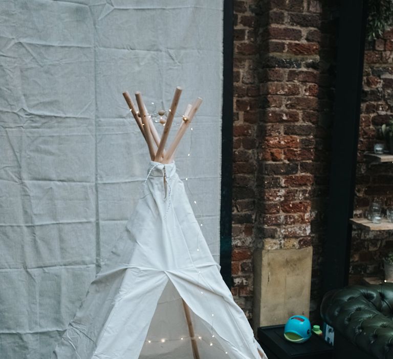 White Teepee with Cushions, Rugs and Fairy Lights | Victoria Stakes Pub Wedding Reception | High Street Wedding Dress for an Intimate Crouch End Pub Wedding with Bright Flowers | Miss Gen Photography