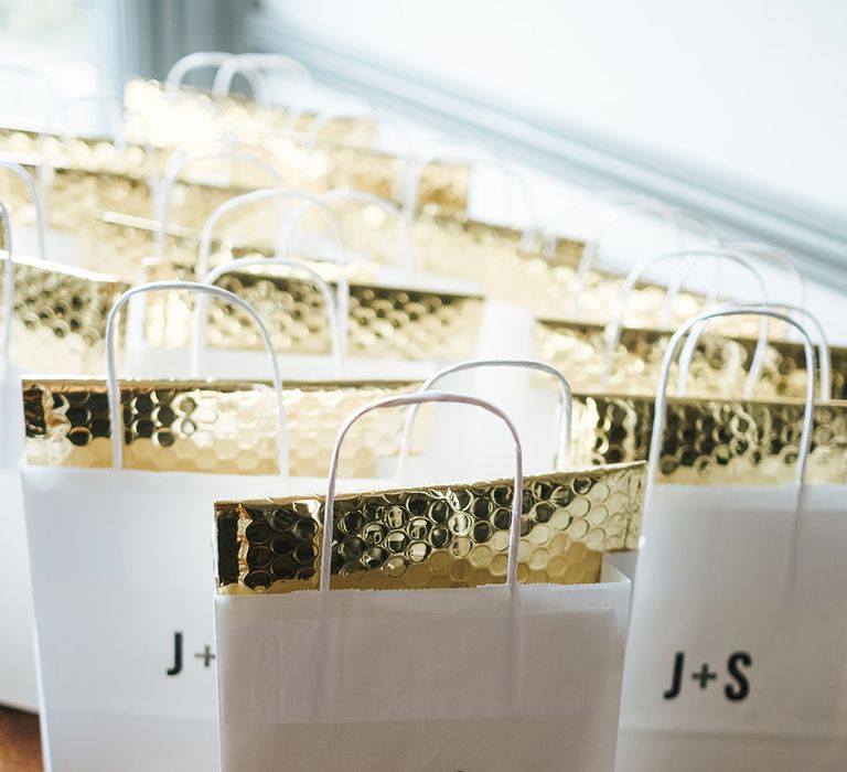 Paper Party Bags with Initials Monogram and Gold Envelopes | Victoria Stakes Pub Wedding Reception | High Street Wedding Dress for an Intimate Crouch End Pub Wedding with Bright Flowers | Miss Gen Photography