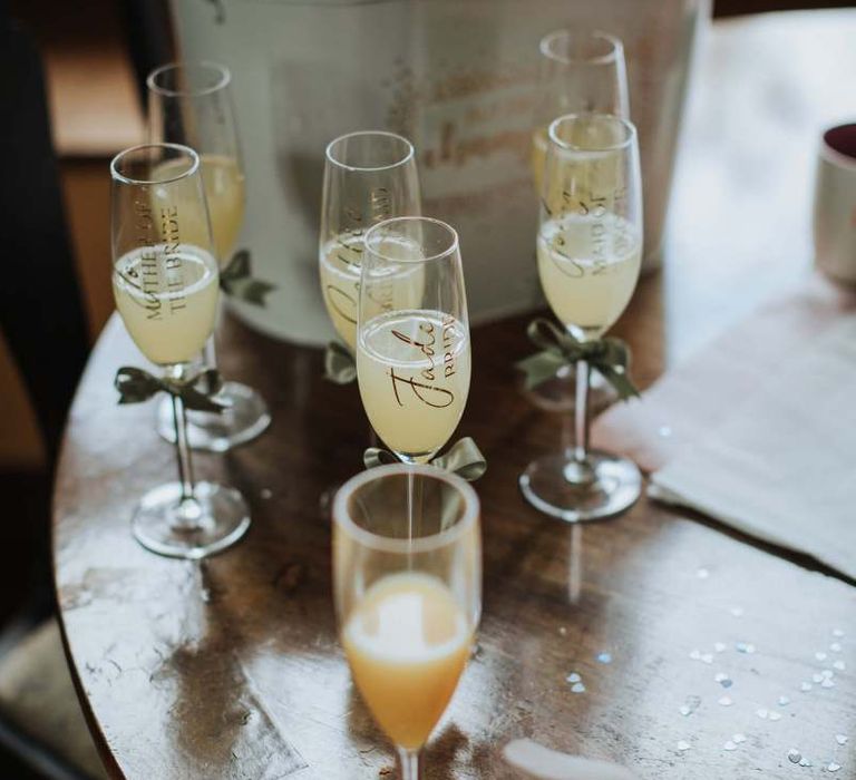 Personalised Champagne Glasses For Marquee Wedding With Floral Backdrop