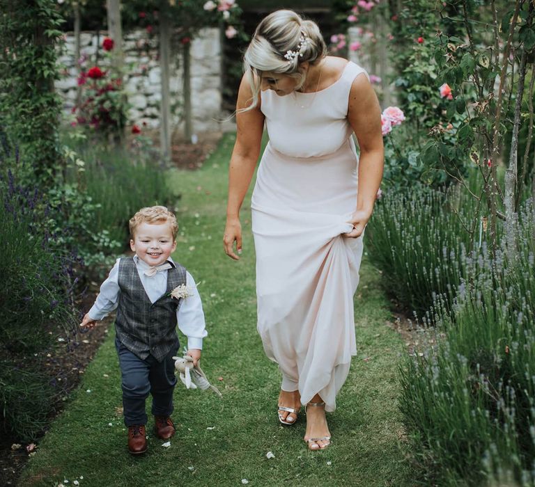 Bridesmaid Accompanies Child At Wedding